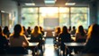 © SarahEvansDesignCo - Young people sitting a classroom with their backs turned facing the front of the class teacher with a whiteboard chalkboard with assignments studying workload