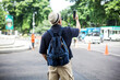 © Queenmoonlite Studio - Traveler Man Wear Backpack Doing Vlog Using Mobile Phone While Walking on City Street