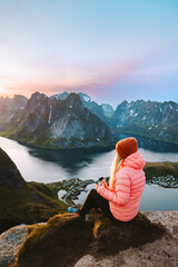 Wall Mural - woman traveling in lofoten islands relaxing on reinebringen mountain top hiking in norway outdoor, g
