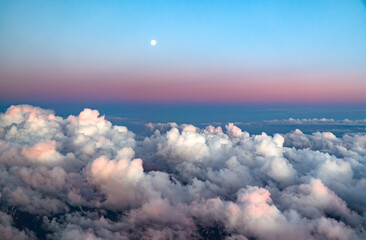 Wall Mural - aerial view of cloud and twilight pink sky before sunrise from airplane