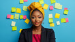 © Bi - Professional woman brainstorming with sticky notes