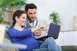 © auremar - couple is watching video on laptop