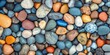 © Rufat - Colorful small round pebbles scattered along the beach create a vibrant and natural display, showcasing the beauty of small round pebbles found in coastal environments.