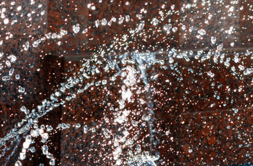 Wall Mural - A wall with water droplets falling from a faucet