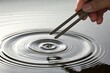 © Jason - Tuning fork make ripple in water. Science and sound wave experiment