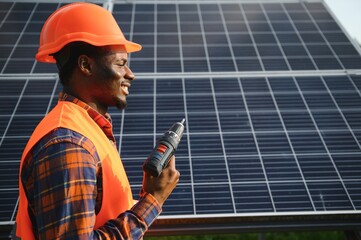 Wall Mural - Portrait of african american electrician engineer in safety helmet and uniform installing solar panels