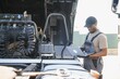 © Serhii - Truck repair service. Mechanic makes computer diagnostic of the semitruck
