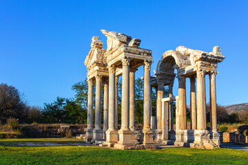 Wall Mural - Tetrapylon of the Temple of Aphrodite at Aphrodisias, featuring elegant marble columns and intricate carvings under clear blue skies. Geyre, Aydin, Turkey (Turkiye)