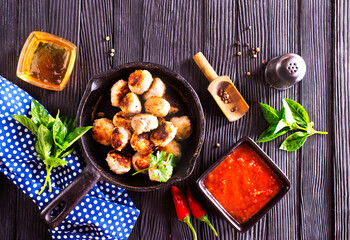 Poster - Fried cutlets from minced meat in frying pan and spices on wooden table.