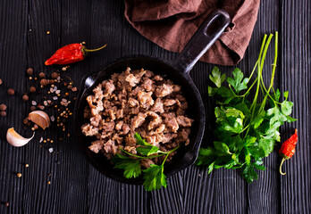 Poster - Pan fried minced meat to Italian pasta. Gray background. Top view.