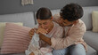 © Krakenimages.com - Man comforting crying woman on a couch in home while sitting indoors together showing love and support