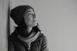 © Markus Schröder - Portrait of a blissful woman in her 30s dressed in a water-resistant gilet in front of bare monochromatic room