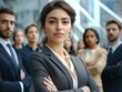 © Oksana - Confident young leader with cross-armed team behind her.