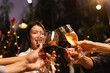 © SOMKID - Group of friends clinking wine glasses in celebration at night, Festival celebration, Happy Asian group friends and dinner party in the night, Friendship and celebration new year concept.