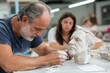 © Milos - An artist meticulously carves a clay bust in a well-lit studio, showcasing the intricate details and the dedication involved in the sculpting process alongside a focused student.