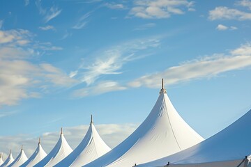 Wall Mural - line of white tents against blue sky