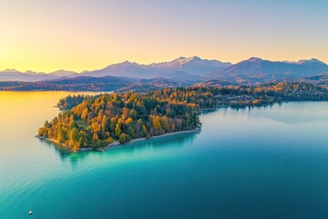Poster - Aerial view of a serene lake surrounded by autumn foliage and mountains at sunset.