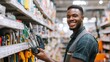 © AlfaSmart - Man is smiling and holding a tool in a store