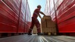 © michnik101 - Worker stacking boxes in a bright red truck trailer on a sunny day. efficient packing