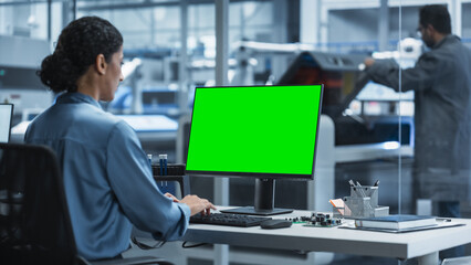 Poster - Hispanic Female Robotics Engineer Using Desktop Computer with Green Screen Chromakey Mock Up Display in Factory Office. Technological Research and Development Facility with Autonomous Assembly Line.
