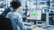 © Gorodenkoff - Hispanic Female Manager And Asian Male Engineer Using Desktop Computer With Microchip Blueprints at Automated Factory With Robotic Arms. Diverse Colleagues Discussing Production Of High-Tech Devices.