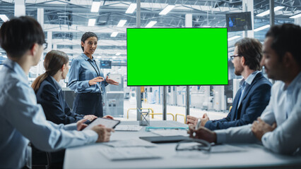 Poster - Electronics Factory Office Meeting: Hispanic Female Project Manager Presenting Innovative High-Tech Device On TV With Green Screen Chromakey. Diverse Engineers And Technicians Listening, Taking Notes.