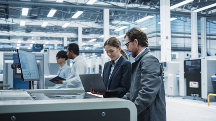 Aufkleber - Caucasian Female Manager Using Laptop And Talking To Male Industrial Engineer At an Electronics Factory. Colleagues Using Soldering Jet Printer For Super Computer Motherboards Production.