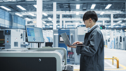 Poster - Asian Male Industrial Engineer Using Laptop To Control Soldering Jet Printer On Modern Electronics Factory. Man Working On Production Of Innovative Printed Circuit Boards For Machine Learning.