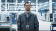 © Gorodenkoff - Portrait of Caucasian Male Facility Technician Standing, Looking at Camera and Smiling. Male Industrial Specialist Wearing a Work Jacket, Working in an Autonomous Electronics Assembling Factory