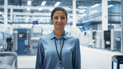 Aufkleber - Portrait of Hispanic Female Facility Technician Standing, Looking at Camera and Smiling. Young Industrial Specialist Working At an Autonomous Electronics Factory, Producing High-Tech Devices.