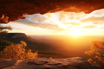 Wall Mural - Breathtaking sunset view from a rocky outcrop over majestic valley and distant mountains in the late evening sky