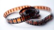 © Bejo Studio - Aged film reel, two intertwined rolls of vintage film stock on white background.