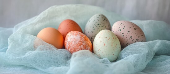 Aufkleber - Pastel Easter eggs arranged on a soft blue cheesecloth background for a festive spring celebration theme
