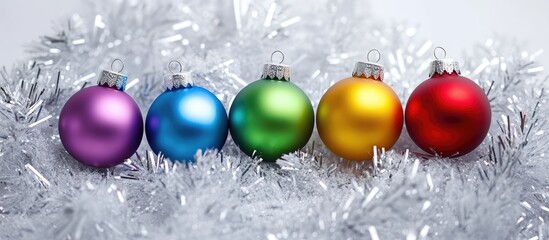 Aufkleber - Colorful Christmas ornaments arranged on silver garland creating a festive holiday background for seasonal decorations and celebrations