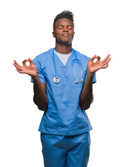 Sticker - Young african american doctor man over isolated background wearing surgeon uniform relax and smiling with eyes closed doing meditation gesture with fingers. Yoga concept.