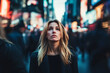 © alexandr - A blonde woman standing in a busy urban street looking upwards amidst blurred crowds and vibrant city lights