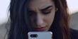 © ArtPixel-Portfolio - Unhappy woman looking at her smartphone with a frown, reacting with concern and frustration to disappointing news outdoors