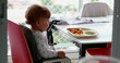 © Marco - Candid toddler baby at highchair eating food