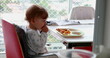 © Marco - Candid toddler baby at highchair eating food