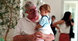 © Marco - Grand-father holding baby grandson in arms