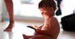 © Marco - Toddler baby using cellphone device