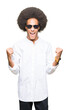 © Krakenimages.com - Young african american man with afro hair wearing sunglasses celebrating surprised and amazed for success with arms raised and open eyes. Winner concept.