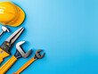 © Piyawan - Modern and vibrant image of handy tools including hard hat, pliers, wrench, and screwdriver on blue background, showcasing professional and organized workspace