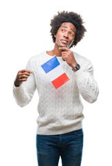 Wall Mural - Afro american man flag of France over isolated background serious face thinking about question, very confused idea