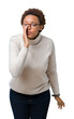 © Krakenimages.com - Young beautiful african american woman wearing glasses over isolated background hand on mouth telling secret rumor, whispering malicious talk conversation