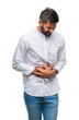 © Krakenimages.com - Adult hispanic man over isolated background with hand on stomach because nausea, painful disease feeling unwell. Ache concept.