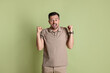 © New Africa - Portrait of happy winner on pale olive background