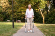 © New Africa - Senior woman with walking frame in park