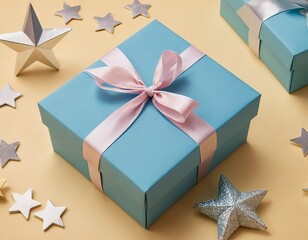 Wall Mural - A beautifully wrapped blue gift box with a pink ribbon, surrounded by glittery stars.