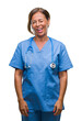 © Krakenimages.com - Middle age senior nurse doctor woman over isolated background winking looking at the camera with sexy expression, cheerful and happy face.